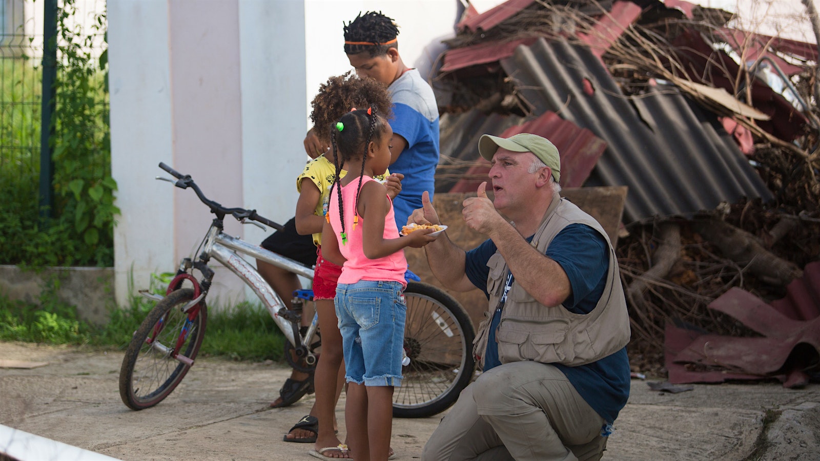 José Andrés, with two thumbs up, talking to children in Puerto Rico.